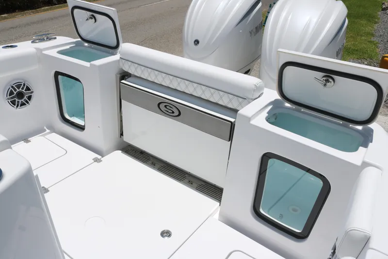 Slide: The Image of 2025 Sportsman Open 282 boat interior with storage compartments and twin engines. - 13