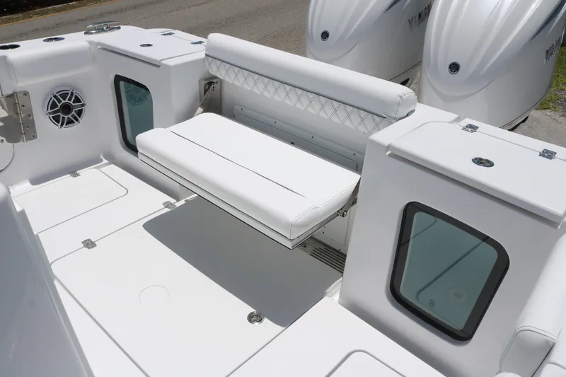 Slide: The Image of 2025 Sportsman Open 282 boat interior with white seating and storage compartments. - 14