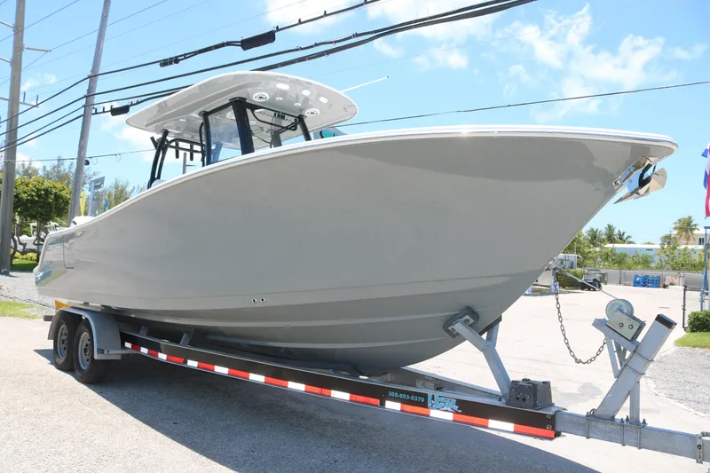 Slide: The Image of 2025 Sportsman Open 282 boat on trailer under clear blue sky. - 2