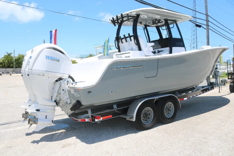 Slide: The Image of 2025 Sportsman Open 282 boat on trailer with Yamaha engine, parked outdoors. - 3