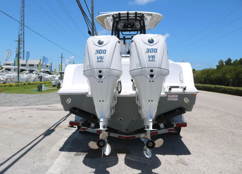Slide: The Image of 2025 Sportsman Open 282 boat with dual 300 V6 engines, parked outdoors. - 5