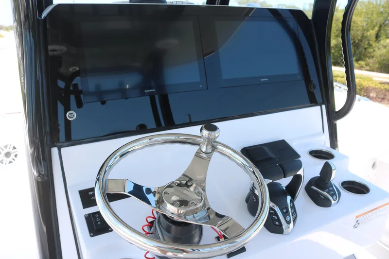 Slide: The Image of 2025 Sportsman Open 282 boat dashboard with steering wheel and controls. - 6