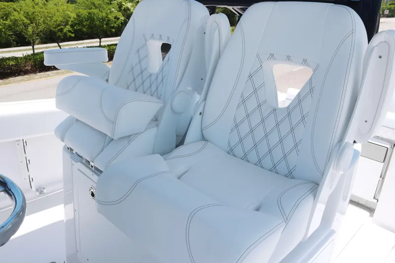 Slide: The Image of Luxurious white seats on 2025 Sportsman Open 282 boat with diamond stitching. - 7