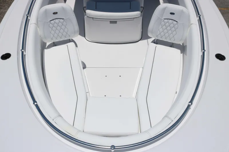 Slide: The Image of 2025 Sportsman Open 282 boat interior with white cushioned seating and sleek design. - 9