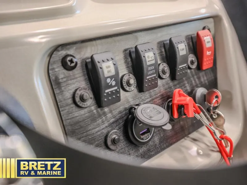 Slide: The Image of Control panel of 2025 Vista Fish 18 boat with switches and keychain. - 12