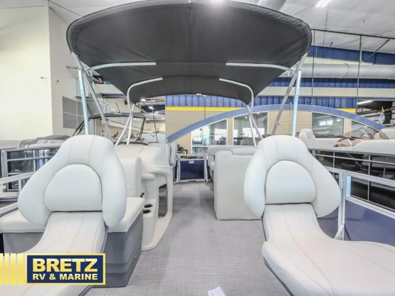 Slide: The Image of 2025 Vista Fish 18 pontoon boat interior with seating and canopy at Bretz RV & Marine showroom. - 13