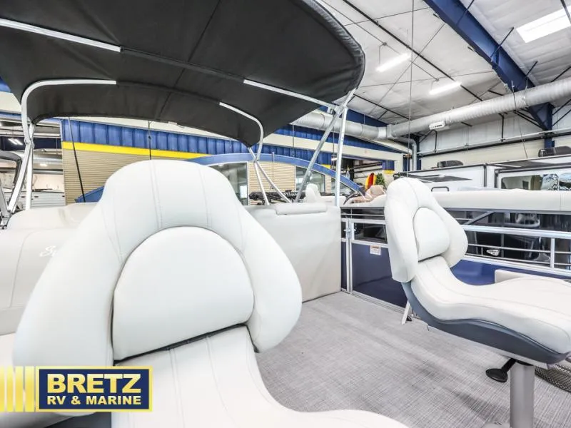 Slide: The Image of 2025 Vista Fish 18 boat interior with white seating, displayed at Bretz RV & Marine showroom. - 14