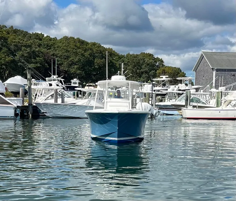 Slide: The Image of 2014 Regulator 25FS Center Console boat docked in a marina. - 5