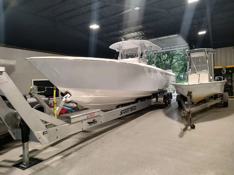 The Image of 2024 Contender 39 ST boat on trailer in indoor storage facility. - 0