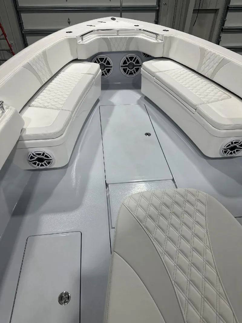 Slide: The Image of 2024 Contender 39 ST boat interior with white cushioned seating and modern design. - 2