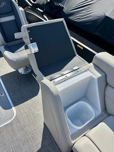 Slide: The Image of 2025 Barletta C22UC boat interior with gray seating and storage compartment. - 10