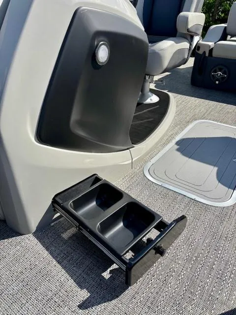 Slide: The Image of 2025 Barletta C22UC boat interior with retractable cup holder and seating. - 11