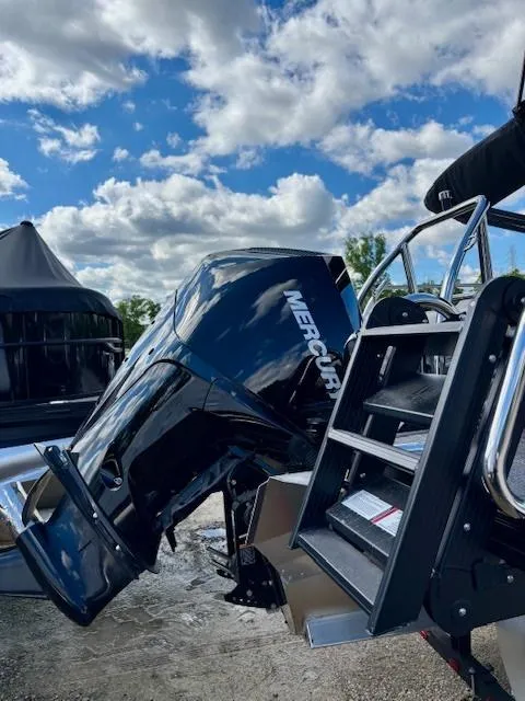 Slide: The Image of 2025 Barletta C22UC boat with Mercury engine under a blue sky. - 12