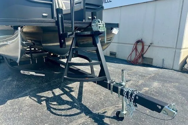 Slide: The Image of 2025 Barletta C22UC pontoon boat trailer hitch and frame in a parking lot. - 16