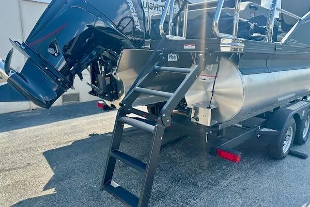 Slide: The Image of 2025 Barletta C22UC pontoon boat with ladder and outboard motor on trailer. - 19
