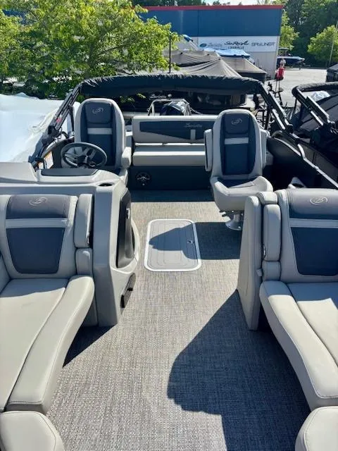 Slide: The Image of 2025 Barletta C22UC pontoon boat interior with plush seating and modern design. - 2