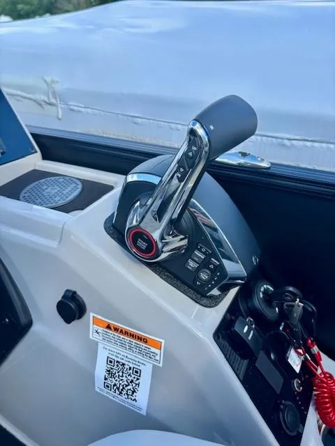 Slide: The Image of 2025 Barletta C22UC boat control panel with throttle and warning label. - 3