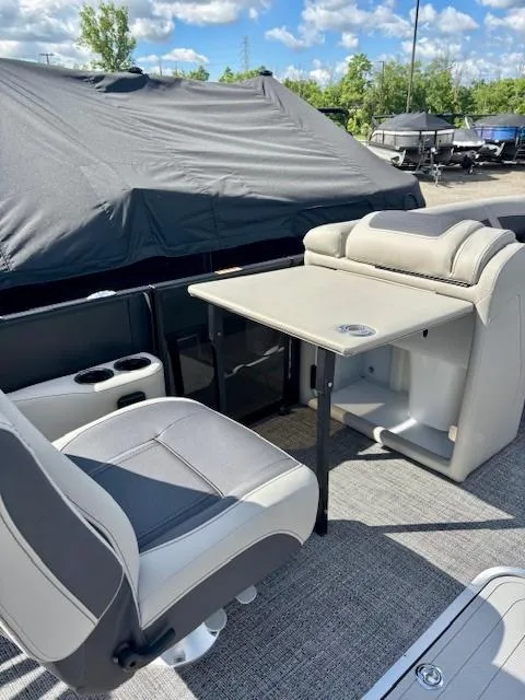 Slide: The Image of 2025 Barletta C22UC pontoon boat interior with seating and table setup. - 5