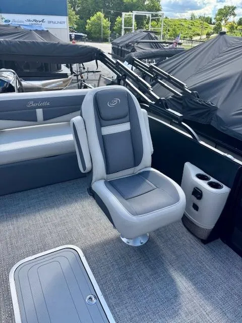 Slide: The Image of 2025 Barletta C22UC boat interior with gray seating and cup holders. - 6