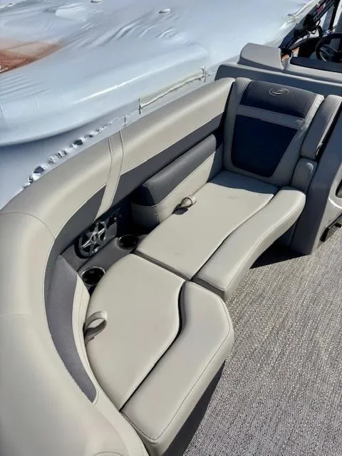 Slide: The Image of 2025 Barletta C22UC boat interior with gray seating and cup holders. - 7