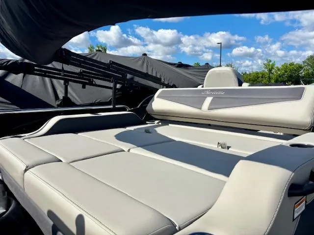 Slide: The Image of 2025 Barletta C22UC boat interior with luxurious seating under a blue sky. - 8