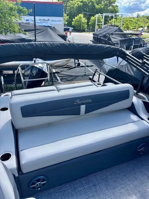 Slide: The Image of 2025 Barletta C22UC pontoon boat with gray seating and sleek design. - 9