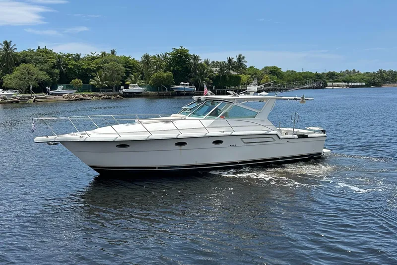 Slide: The Image of 2000 Tiara Yachts 3700 Open cruising on a sunny day in a scenic waterway. - 0