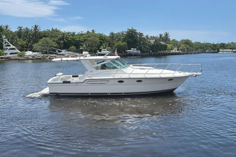 Slide: The Image of 2000 Tiara Yachts 3700 Open cruising on a serene waterway. - 1