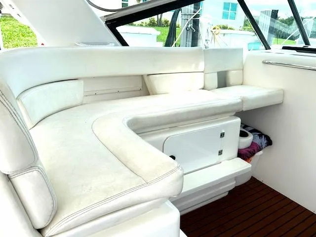 Slide: The Image of 2000 Tiara Yachts 3700 Open interior with white seating and wooden flooring. - 11