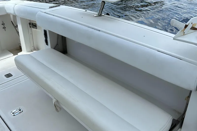 Slide: The Image of Tiara Yachts 3700 Open 2000 model, white seating area on deck by water. - 18