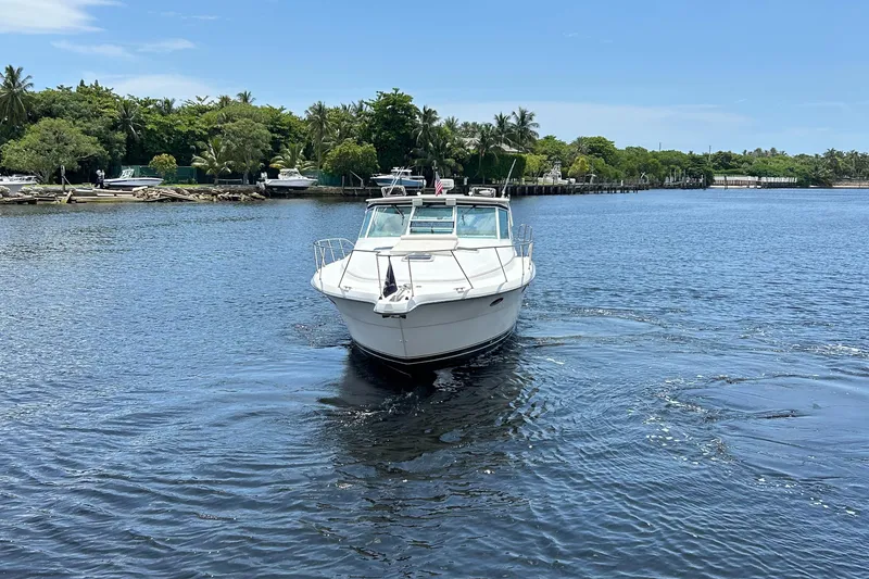 Slide: The Image of 2000 Tiara Yachts 3700 Open cruising on a serene waterway. - 2