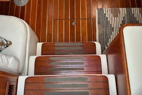 Slide: The Image of Wooden steps on a 2000 Tiara Yachts 3700 Open, featuring a striped rug. - 28