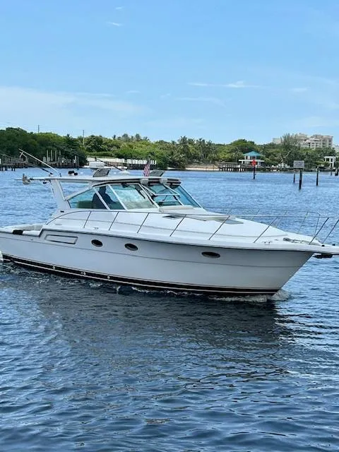 Slide: The Image of 2000 Tiara Yachts 3700 Open cruising on a calm, scenic waterway. - 3