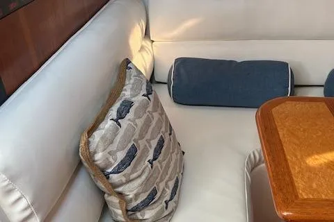 Slide: The Image of Interior of 2000 Tiara Yachts 3700 Open with cushions and wooden table. - 31