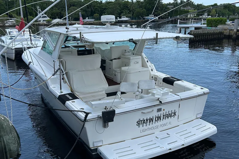Slide: The Image of 2000 Tiara Yachts 3700 Open docked at marina, rear view. - 7