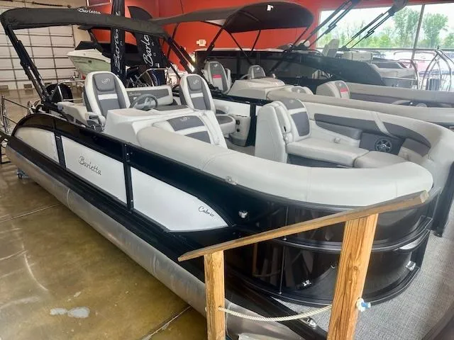 The Image of 2025 Barletta C22UC pontoon boat with sleek design and comfortable seating in showroom. - 0