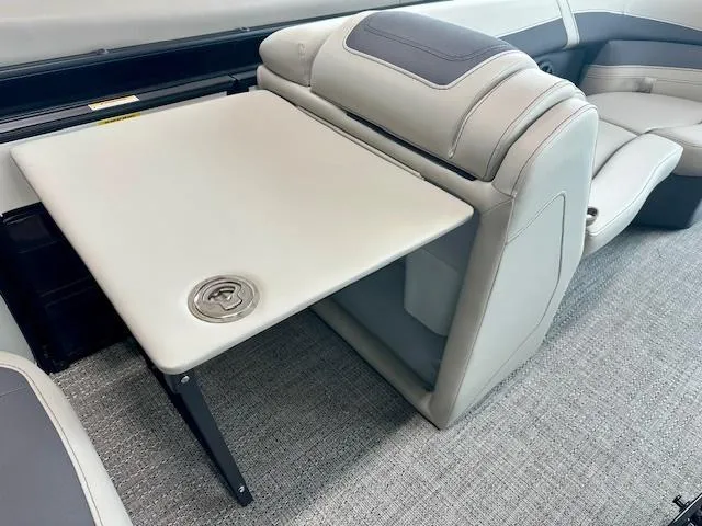 Slide: The Image of 2025 Barletta C22UC boat interior with foldable table and cushioned seating. - 8