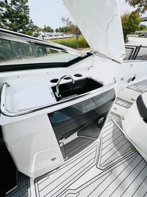 Slide: The Image of 2019 Monterey 298 Super Sport boat interior with sink and storage. - 11