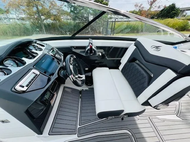 Slide: The Image of 2019 Monterey 298 Super Sport boat interior with modern dashboard and seating. - 7
