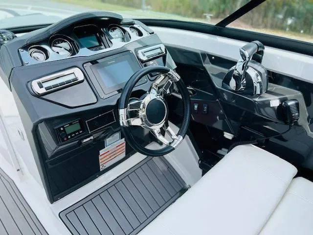Slide: The Image of 2019 Monterey 298 Super Sport boat dashboard with modern controls and steering wheel. - 8