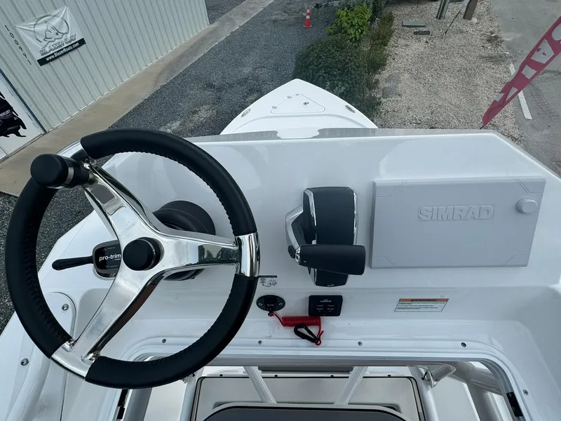 Slide: The Image of 2025 Blazer 2700 Hybrid Bay boat helm with steering wheel and controls. - 11