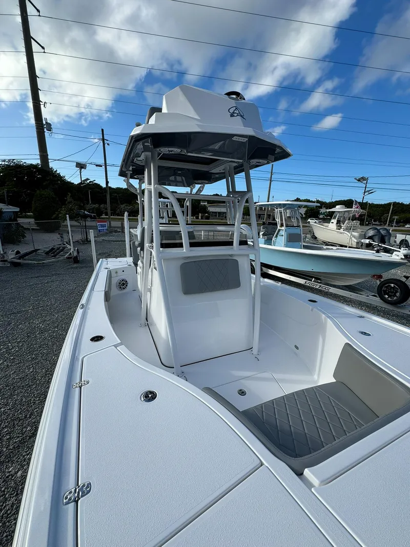 Slide: The Image of 2025 Blazer 2700 HYBRID BAY W/ TOWER boat, sleek design, parked outdoors. - 14
