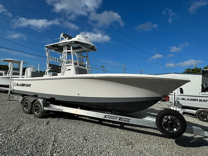 The Image of 2025 Blazer 2700 Hybrid Bay boat with tower on trailer, parked outdoors. - 0