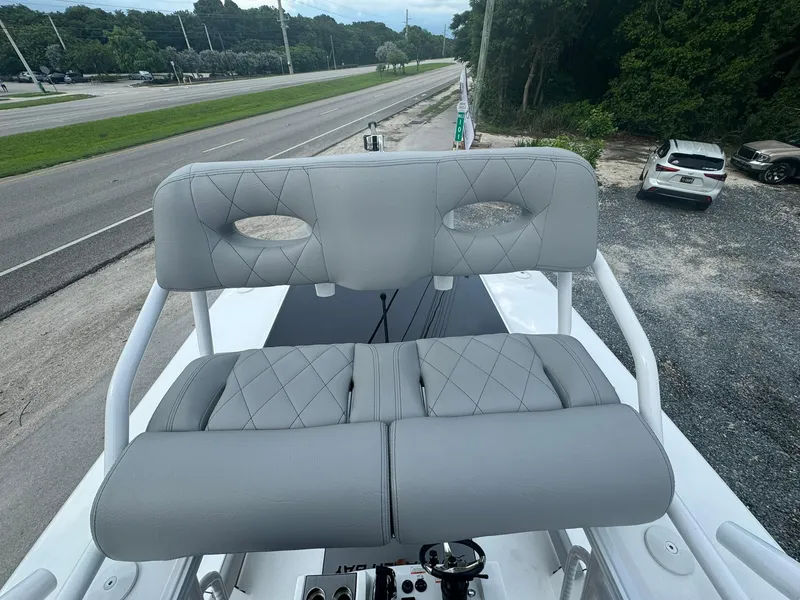 Slide: The Image of 2025 Blazer 2700 Hybrid Bay boat with tower, featuring gray cushioned seating. - 12