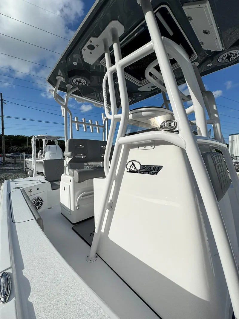 Slide: The Image of 2025 Blazer 2700 HYBRID BAY boat with tower, sleek design under blue sky. - 15