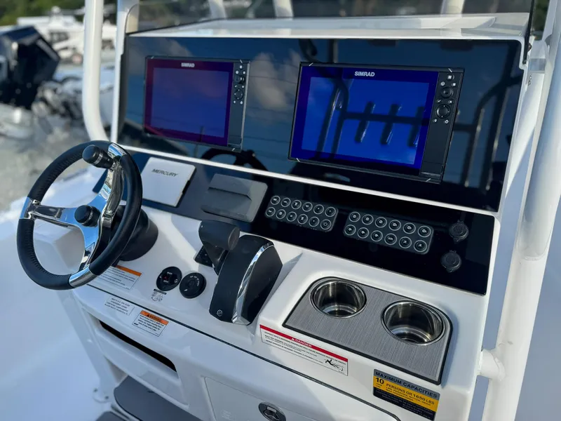 Slide: The Image of 2025 Blazer 2700 HYBRID BAY boat dashboard with dual Simrad displays and steering wheel. - 5