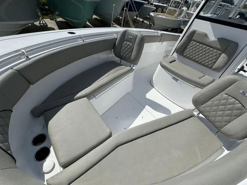 Slide: The Image of 2025 Sportsman Open 282 boat interior with cushioned seating and cup holders. - 10