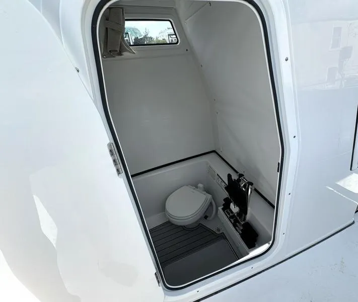 Slide: The Image of 2025 Sportsman Open 282 boat interior with compact marine toilet. - 17