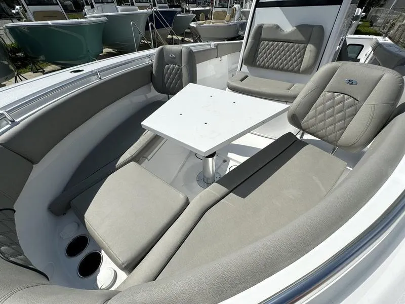 Slide: The Image of 2025 Sportsman Open 282 boat interior with cushioned seating and table. - 19