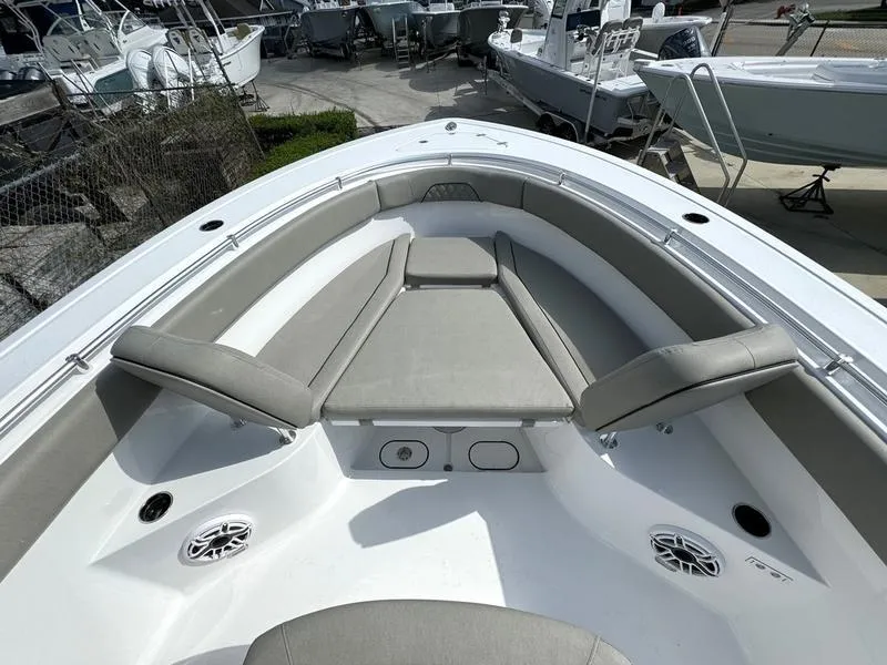 Slide: The Image of 2025 Sportsman Open 282 boat interior with cushioned seating and speakers. - 20